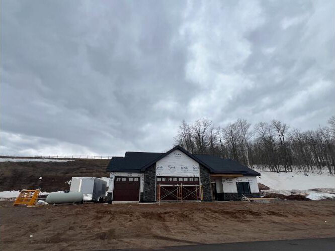 The house features three-bedrooms, a large garage and sauna.