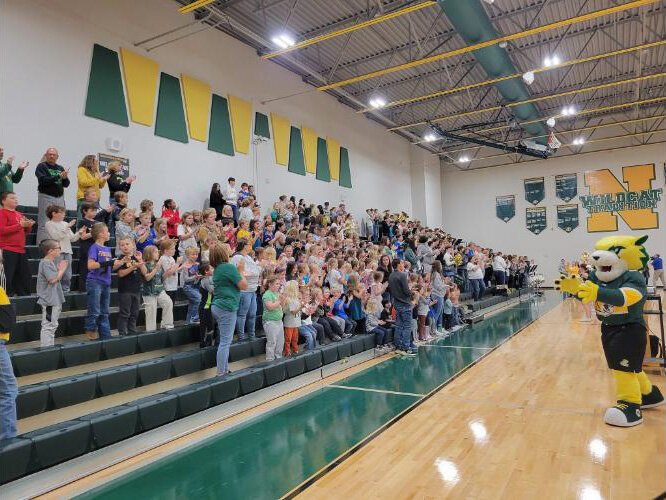 Northwestern Area School District parents, students and staff participate in a pep rally on Nov. 4, celebrating the collaboration between the school district and Northern Michigan University. 