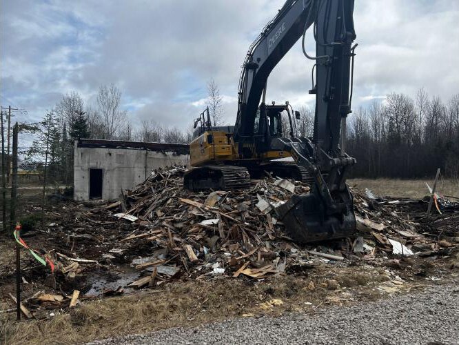 A building being demolished at the Trading Post site.