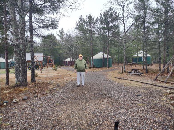 Uncle Ducky stands near his yurts, part of his growing enterprise in and around Munising.