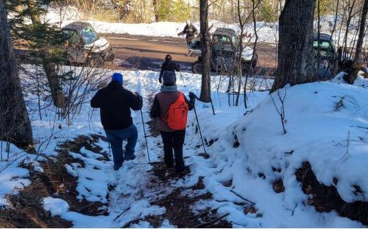 Participants hiking on a guided tour with the Polaris electric ORVs.