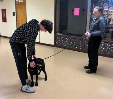 LaSalle High School student interacts with Nova and K9 Team handler Jessica Myjak.