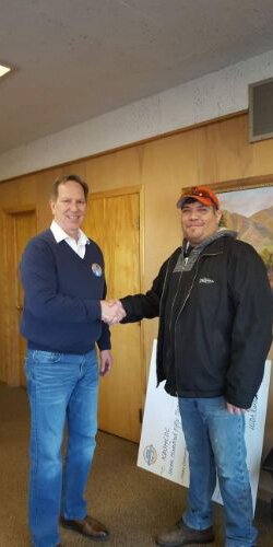 Eddy Michael Edwards (left), executive director of Lake Superior CDC, congratulates a new homeowner. 