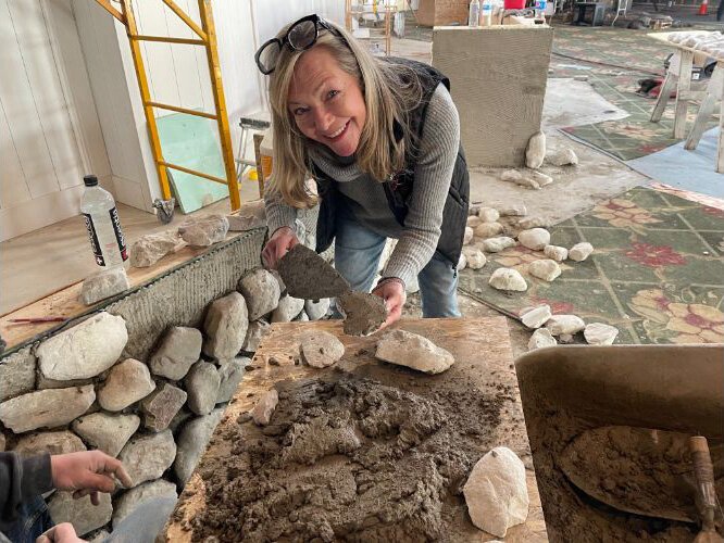 Liz Ware helps with the construction of the new front desk.