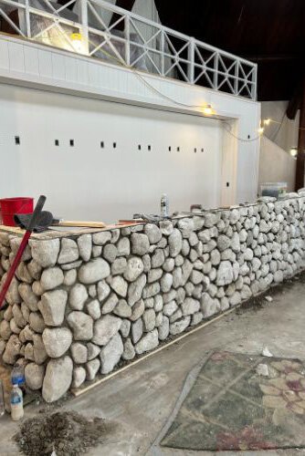 The new front desk was built with rocks collected from the island. 