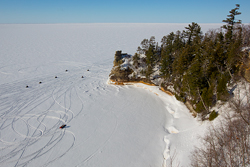 flying in formation, cruising Pictured Rocks by sled