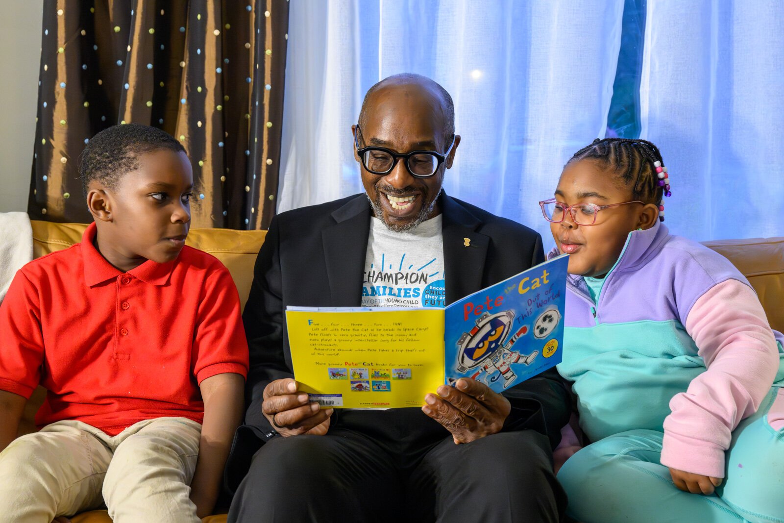 James Ribbron reads to Dwayne Sharpe and Elizabeth Brooks.
