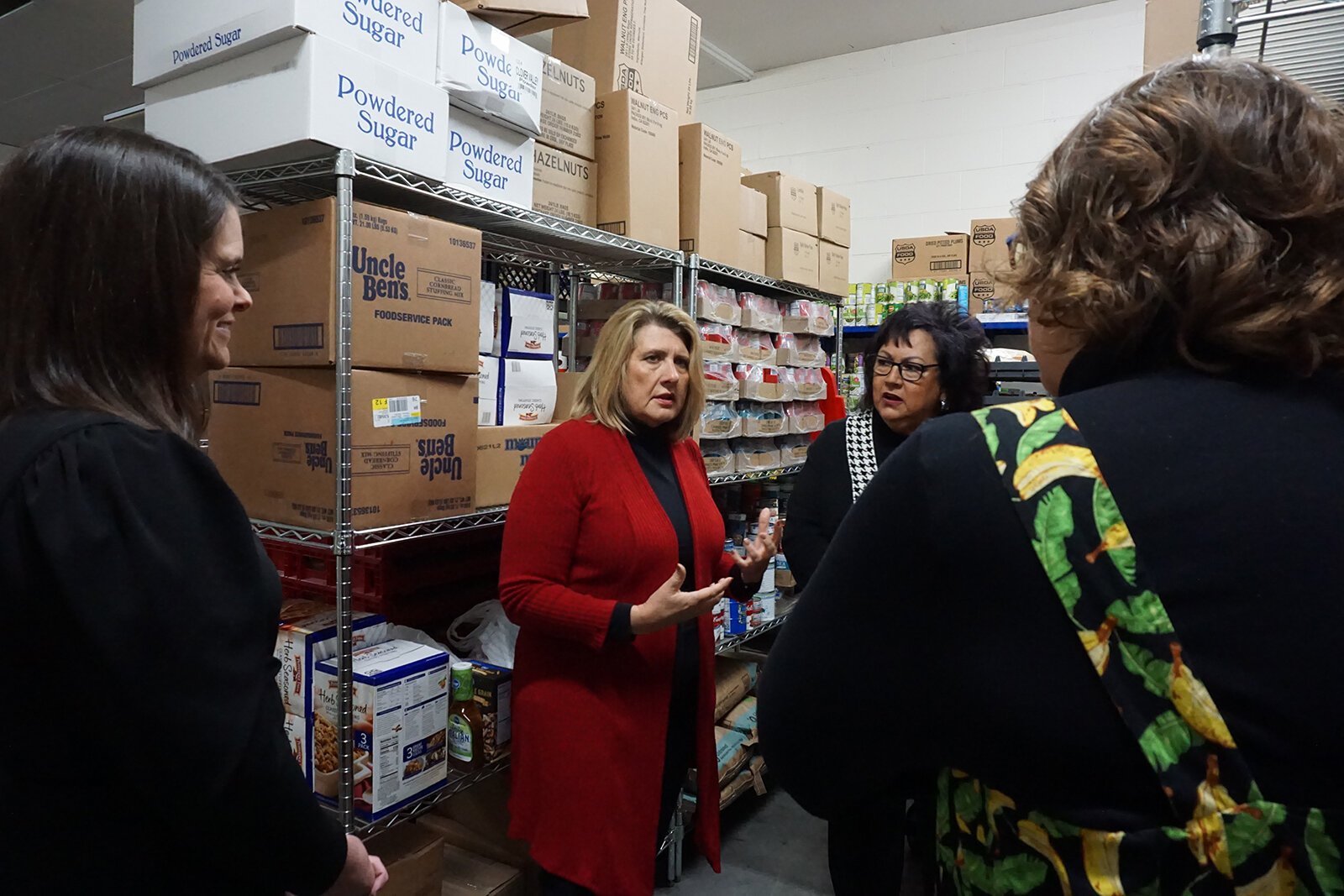 Tina Swanton, MiHIA executive director of community impact and strategic partnerships; MiHIA CEO Heidi Tracy; East Side Soup Kitchen Executive Director Diane Keenan; and Hidden Harvest President and CEO Samantha McKenzie confer.