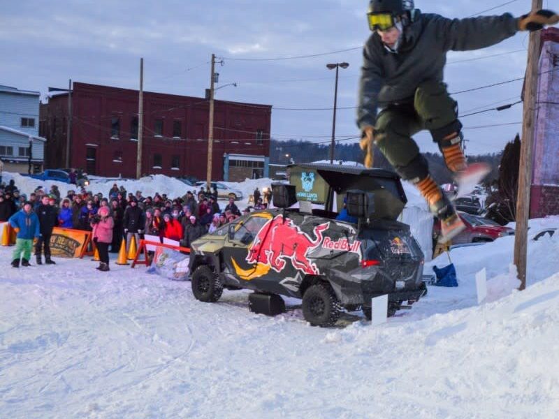 A skier hops on the urban rail jam at the 2022 Heikki Lunta festival in Negaunee.