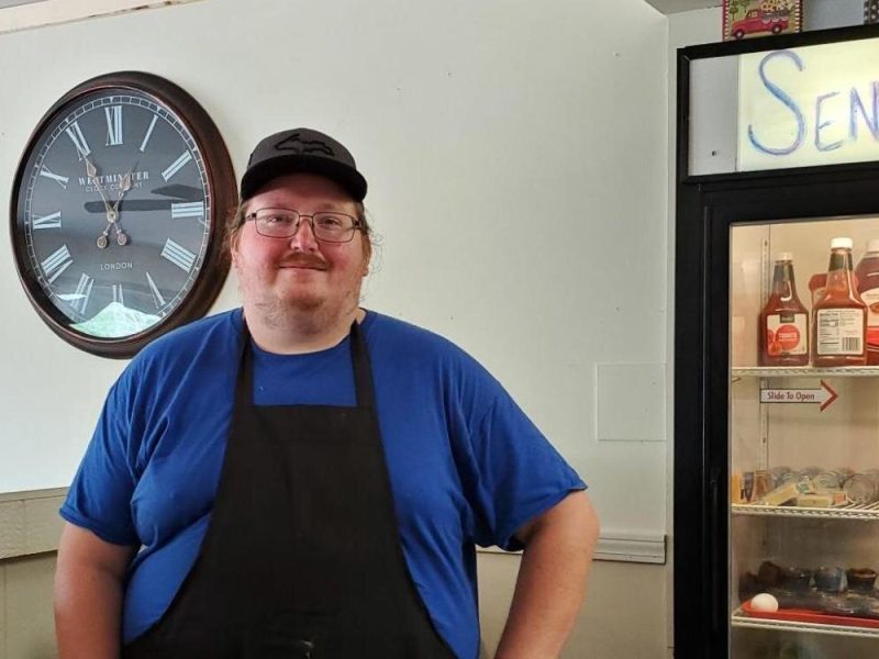 Ryan Smith stands behind the counter of his new restaurant, Seney Crossing, in Seney, Mich.